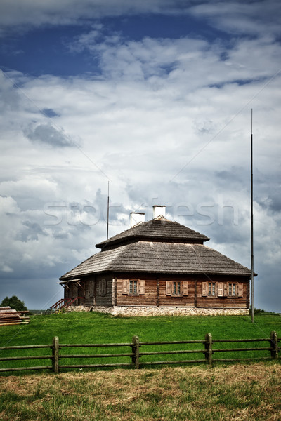 wooden cottage on green hill Stock photo © PetrMalyshev