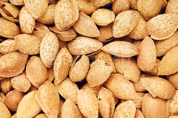 Unpeeled Almonds Nuts Background Stock photo © PetrMalyshev