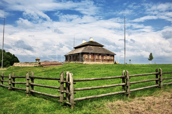 wooden cottage on green hill Stock photo © PetrMalyshev