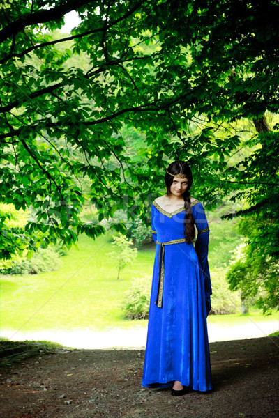 beautiful princess in shadow of big trees Stock photo © PetrMalyshev