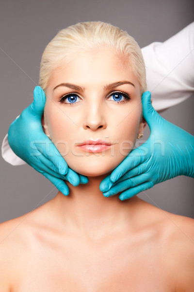 Cosmetic plastic surgeon touching aesthetics face Stock photo © phakimata