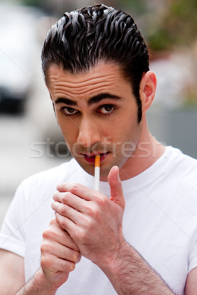 Man lighting cigarette Stock photo © phakimata