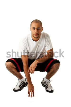 Stock photo: Crouching Sporty guy