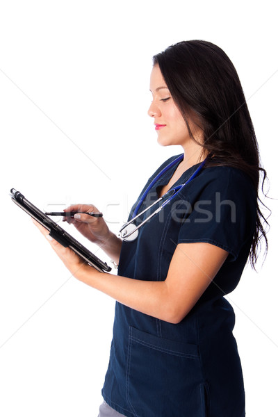 Nurse writing digital patient chart Stock photo © phakimata