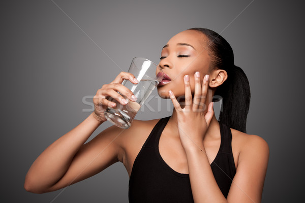 Happy healthy black asian woman enjoying water Stock photo © phakimata