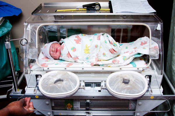 Cute sick baby in incubator Stock photo © phakimata