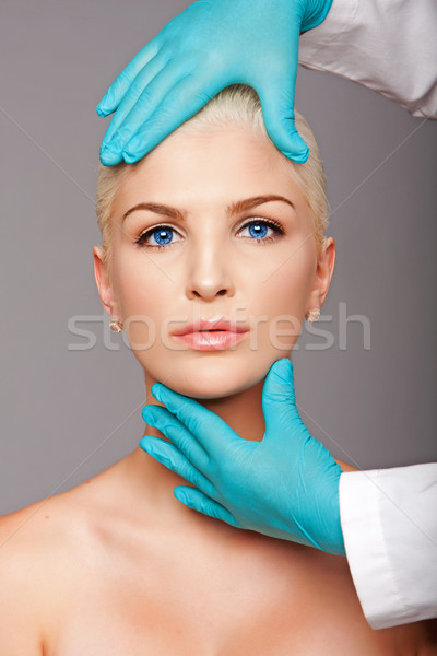 Cosmetic plastic surgeon touching aesthetics face Stock photo © phakimata