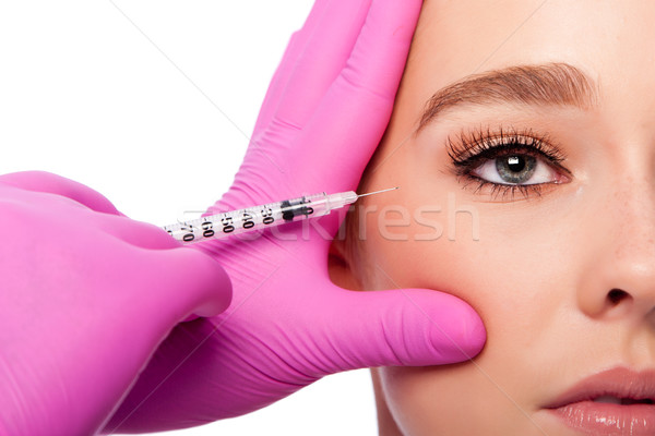 Beauty collagen filler injection in crows feet at eye Stock photo © phakimata