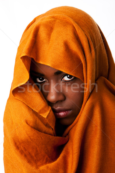 Mysterious female face in ocher head wrap Stock photo © phakimata