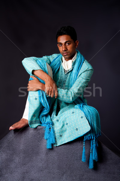 Hindu man sitting on rock Stock photo © phakimata