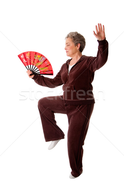Senior woman doing Tai Chi Yoga exercise Stock photo © phakimata