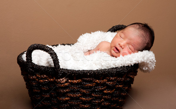 Cute baby asleep in basket Stock photo © phakimata