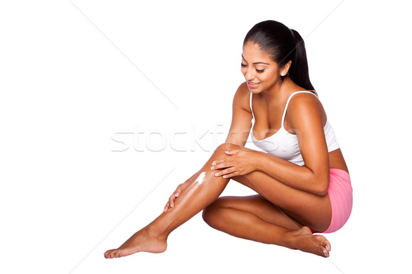 Woman applying Moisturizing lotion  Stock photo © phakimata