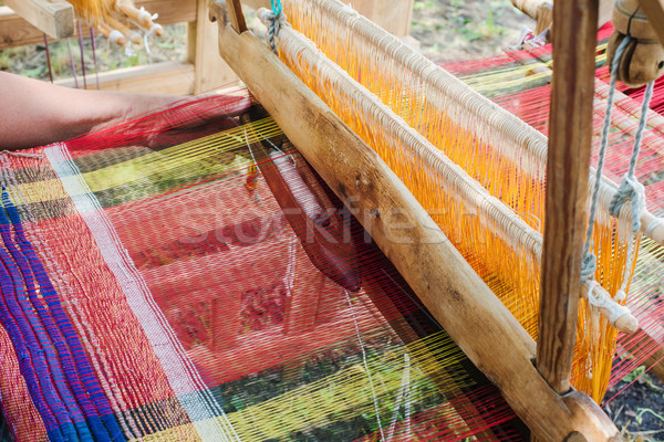 Stock photo: Weaving on a wooden loom