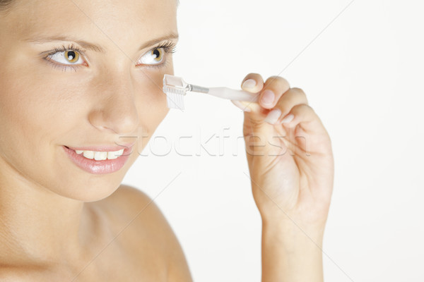 Stock photo: portrait of young woman making her eyelashes