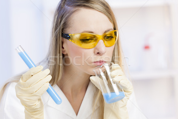 portrait of young woman doing experiment in laboratory Stock photo © phbcz