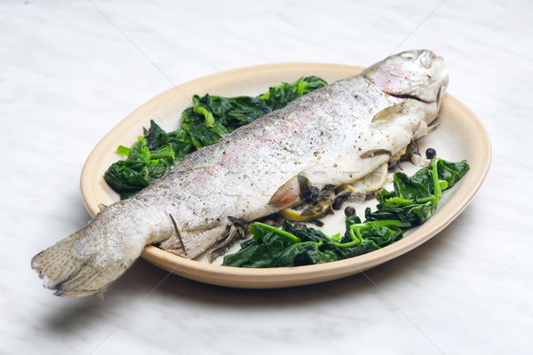 bream baked with Italian herbs and fried spinach Stock photo © phbcz