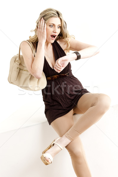 sitting woman looking at wristwatch Stock photo © phbcz