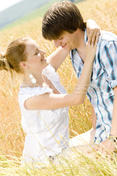 young couple sitting in grain field Stock photo © phbcz