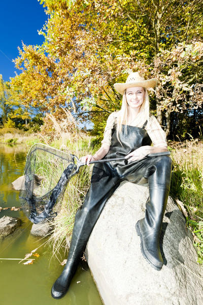 fisher woman with landing net sitting on stone Stock photo © phbcz