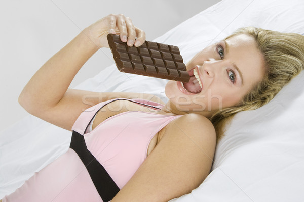 portrait of lying woman with chocolate Stock photo © phbcz