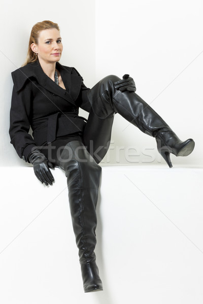 sitting woman wearing black clothes and boots Stock photo © phbcz