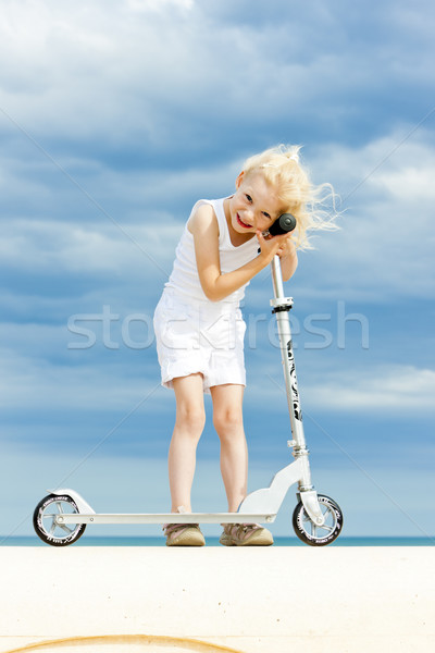 Stock photo: little girl with a scooter