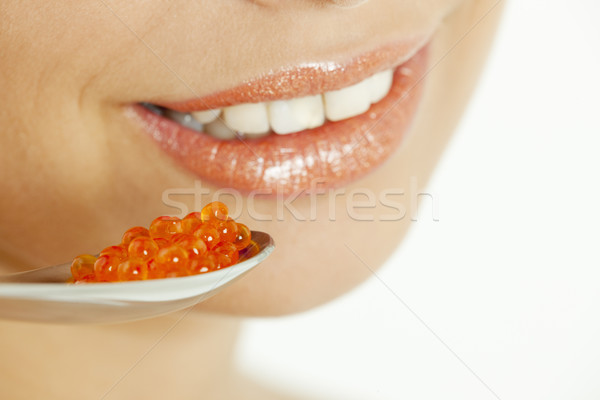 Pormenor mulher vermelho caviar boca dentes Foto stock © phbcz