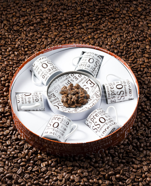coffee cups stored in a box on coffee beans Stock photo © phbcz