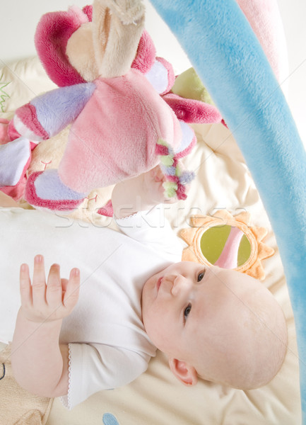 Stock photo: baby girl lying down on playing mat