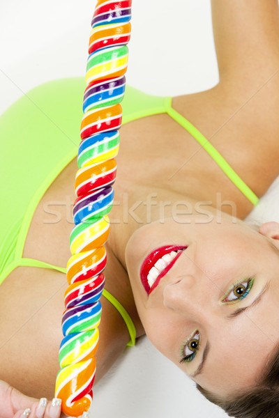 portrait of lying woman with a lollypop Stock photo © phbcz