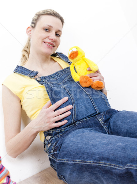portrait of sitting pregnant woman holding a toy for a baby Stock photo © phbcz
