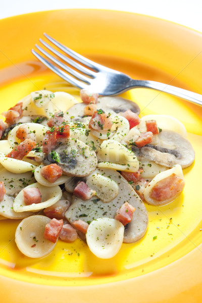 pasta orecchiette with bacon and champignons Stock photo © phbcz