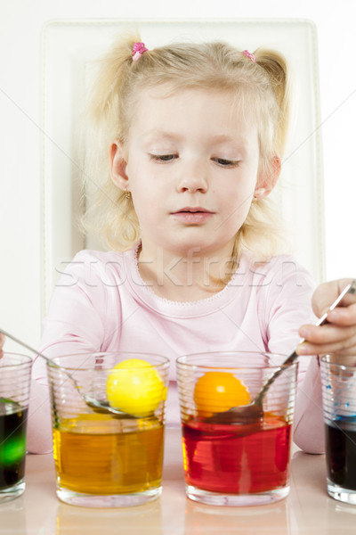 portrait of little girl during Easter eggs' coloration Stock photo © phbcz