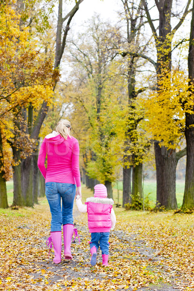Stock photo: mother with her daughter in autumnal alley