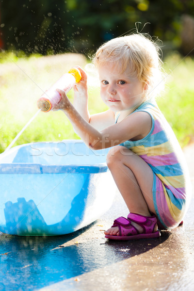 toddler girl playing with water sprayer in summer Stock photo © phbcz