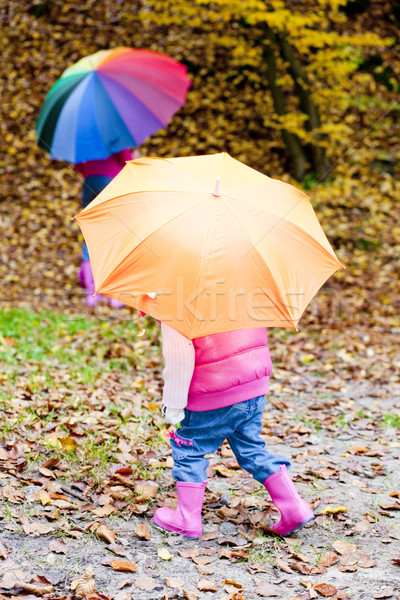 mother and her daughter with umbrellas in autumnal nature Stock photo © phbcz