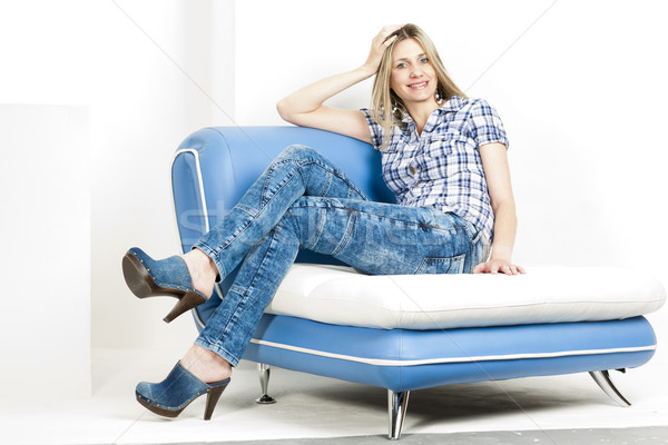 женщину сидят диван джинсов джинсовой Сток-фото © phbcz