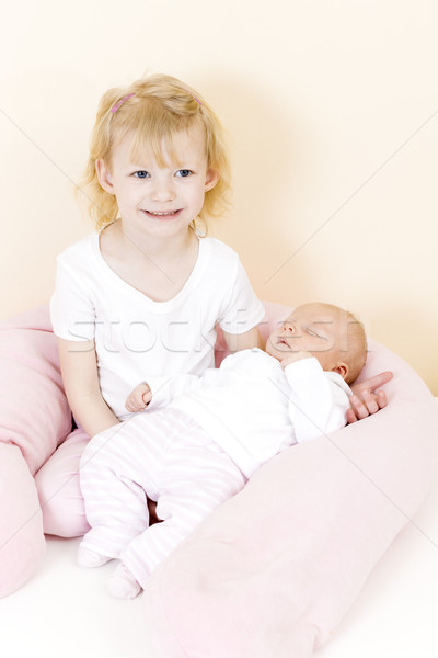 portrait of a little girl cradling her one month old baby sister Stock photo © phbcz