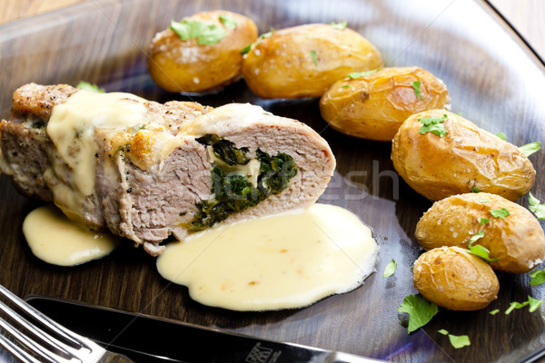 Stock photo: baked pork tenderloin filled with spinach and goat cheese on cre