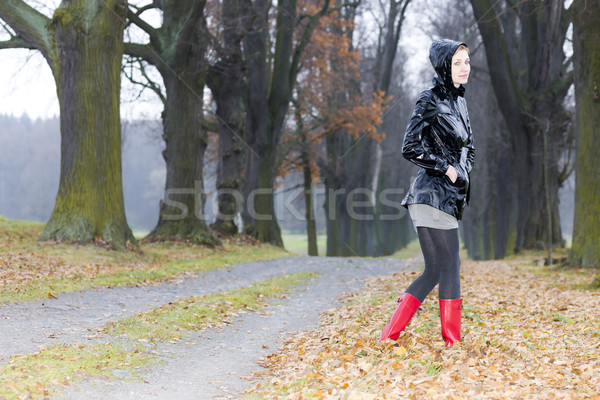 woman wearing rubber boots in autumnal alley Stock photo © phbcz