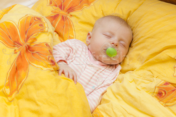 sleeping baby girl in big bed Stock photo © phbcz