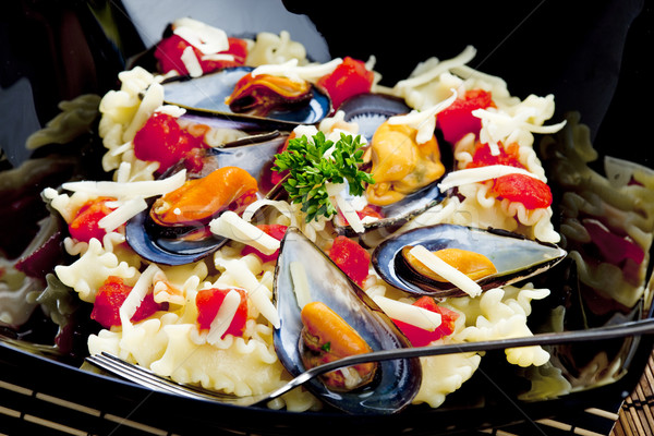 pasta with mussels and chopped tomatoes Stock photo © phbcz