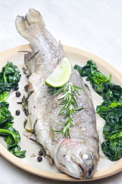 bream baked with Italian herbs and fried spinach Stock photo © phbcz