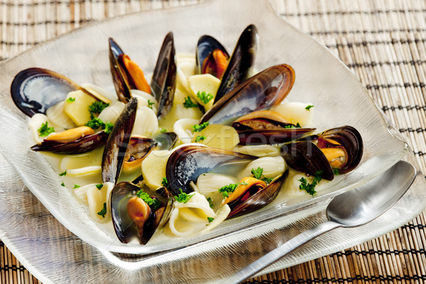 mussels soup with pasta orecchiette Stock photo © phbcz