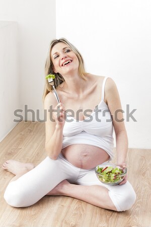 lying down woman eating salad Stock photo © phbcz