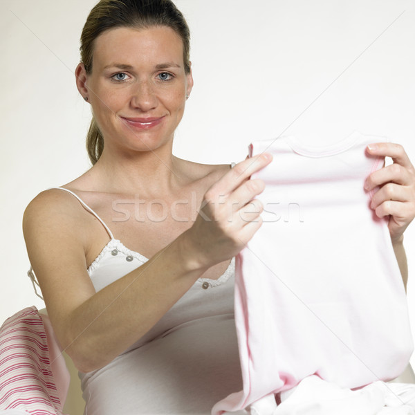 pregnat woman with clothes for babies Stock photo © phbcz