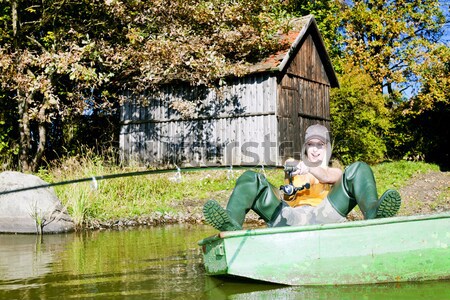 fishing woman sitting on boat Stock photo © phbcz