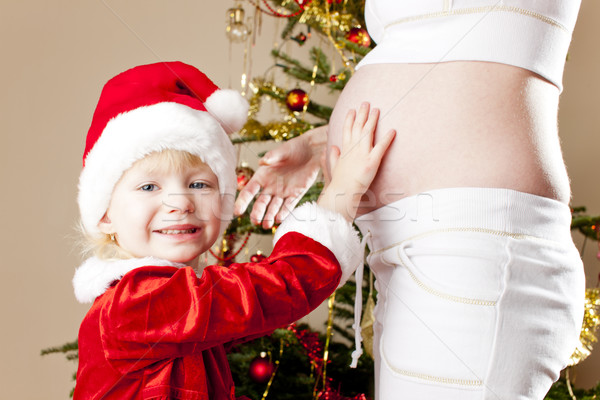 portrait of little girl and her pregnant mother by Christmas tre Stock photo © phbcz