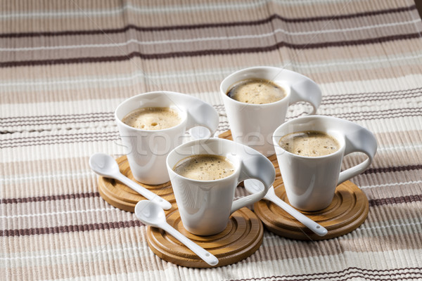 cups of coffee on place mats Stock photo © phbcz